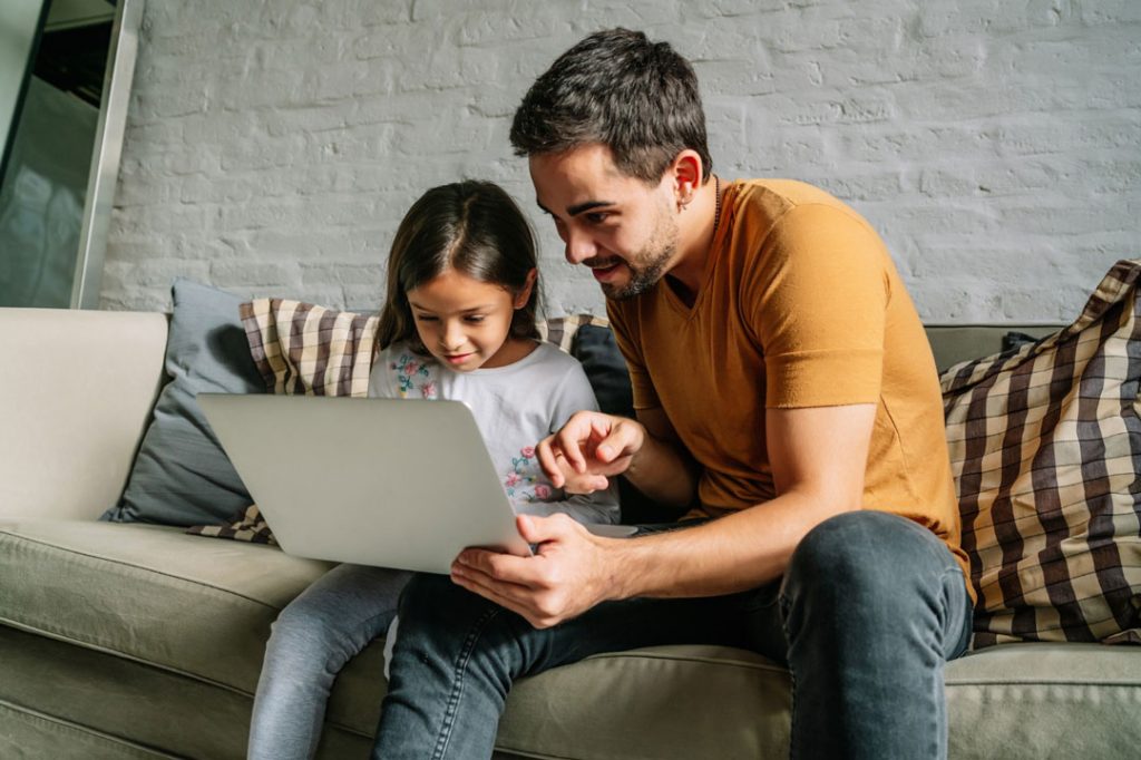 little-girl-her-father-using-laptop-together-home